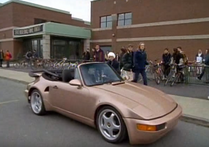 To cheer him up, Belle gives him a brown sports to drive himself home in