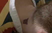 A strange tattoo is seen on Tom's neck