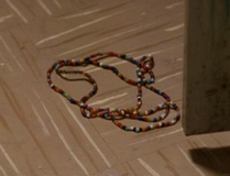 She finds a beaded necklace that fell out of her locker