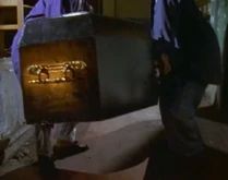 Felix helps Colin move the coffin into the incinerator