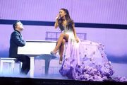 Grande performing "" at The Honeymoon Tour alongside pianist .