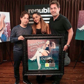 Ariana holding platinum certificate for problem