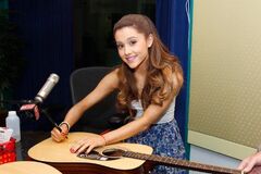 Ariana signing a guitar 