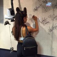 Ariana signing glass wall