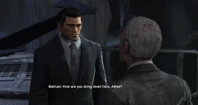 Bruce conversing with Alfred in the Batcave