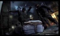 Black Mask getting beaten on by the TYGER Guards at the Arkham City Processing Center
