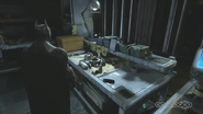 The Line Launcher Prototype on Batman's Workbench in the Batcave in Arkham Origins.