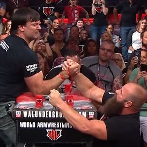 Michael Todd Arm Wrestling Wiki Fandom Arm wrestling rules there's no doubt arm wrestling has gone on in some form or another for the type of arm wrestling table used is different depending upon whether the arm wrestling is to be for stand up matches, the table top should be 40 from the floor. michael todd arm wrestling wiki fandom