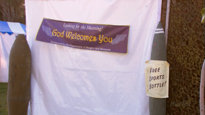 The church's "Looking for the Meaning? God Welcomes You" banner, at the Church and State Fair ("Notapusy")