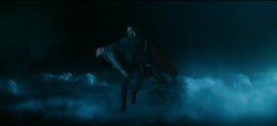 Superman carries Tag into the sky