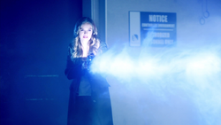 Caitlin Snow using the cold gun to attack .