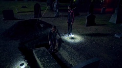 Laurel and Thea dig up Sara's grave