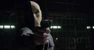 Slade in his old mask pointing a gun