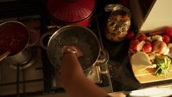 Sam submerges her hand in boiling water