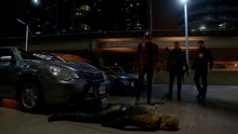 The Flash, Firestorm, and The Arrow stand over a defeated Reverse-Flash