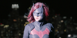Batwoman looking at a helicopter