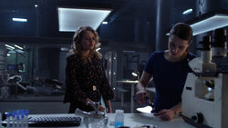 Eve working with Lena to find a cure for Sam