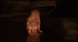 Ra's uses the Lazarus Pit to heal his cut hand