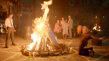 Constantine and Papa Midnite burn the corpses of the spirits
