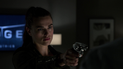 Lena Luthor points a gun at Morgan Edge