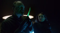 Astra's associate inspects the Green Kryptonite dagger