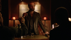 Anatoly greets Oliver and Diggle in his office