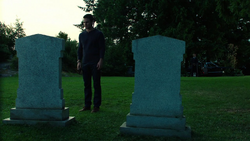 Oliver visits his father's grave