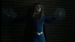 Supergirl is bound by cobwebs.