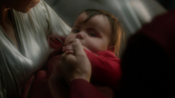 Baby Kal-El being held by his parents