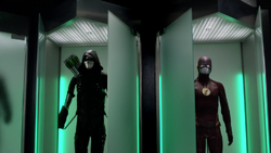 Green Arrow suit and the Flash suit side by side