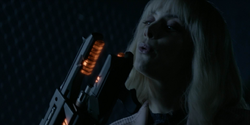 Alice shows to Rifle that the Hamilton Dynamics weapon works