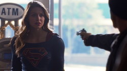 Supergirl talking the armed robber out of robbing a convenience store