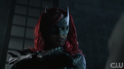 Batwoman threatens a False Face thug