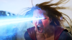 Supergirl angrily firing a blast of heat vision at Red Tornado