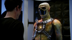 Harrison Wells looks at the modified yellow suit