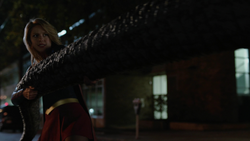Supergirl pulling on Spike's tail.
