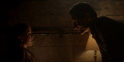 August threatens Beth in the basement