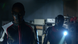 Mister Terrific and Wild Dog discover the hideout of the Vigilante