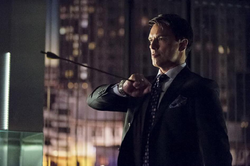 Malcolm Merlyn catches an arrow