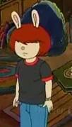 Molly in a black shirt with a red collar and jeans, in "Don't Ask Muffy"