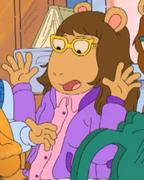 Wearing a purple jacket and a pink button-up collared shirt in a Thanksgiving photo seen in "An Arthur Thanksgiving."