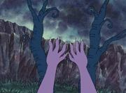 A mysterious pair of purple hands move aside some of the tree branches near the path to the mansion.