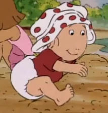 Kate in a bathing shirt, swim diaper, and polka-dot bathing cap.