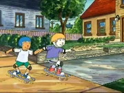 Brian wearing his summer clothes and on a skateboard with Patrick.