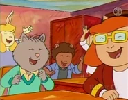 In Mrs. Fink's class along with her classmates.