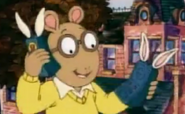 Arthur holding two Bionic Bunny Walkie Talkies while bouncing on a trampoline at the Tibbles' house.