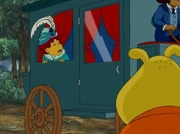 Muffy peeks out the carriage window.