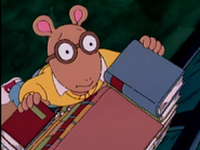Climbing a stack of books in "Locked In the Library"