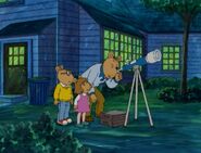 Mr. Read looking through a telescope in "D.W. Aims High."