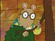 Hiding behind a tree branch in "Arthur's Birthday"